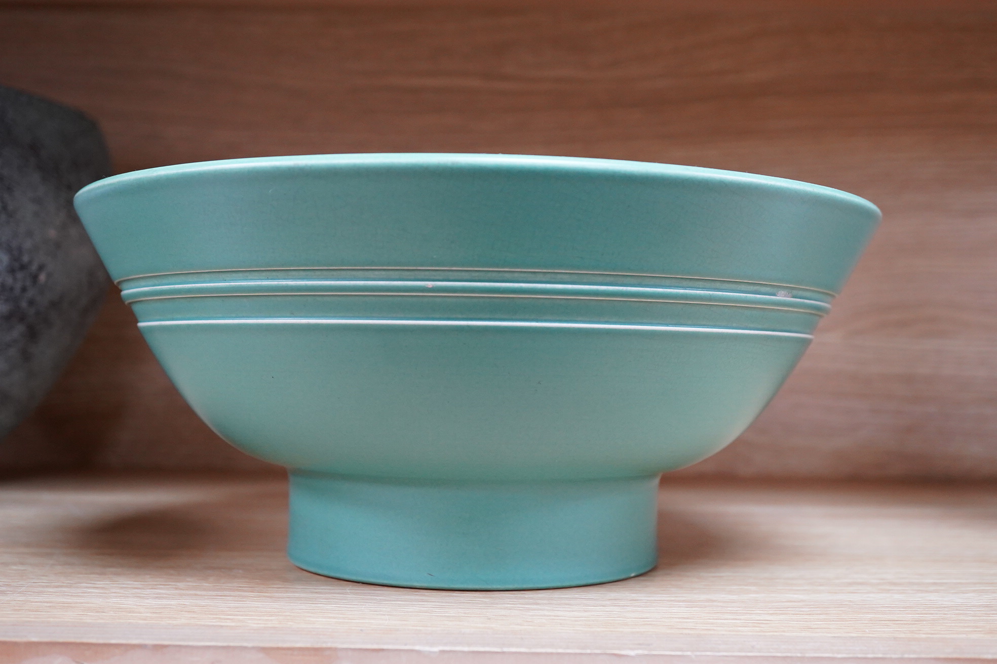 Keith Murray for Wedgwood green glazed footed bowl, 28cm in diameter